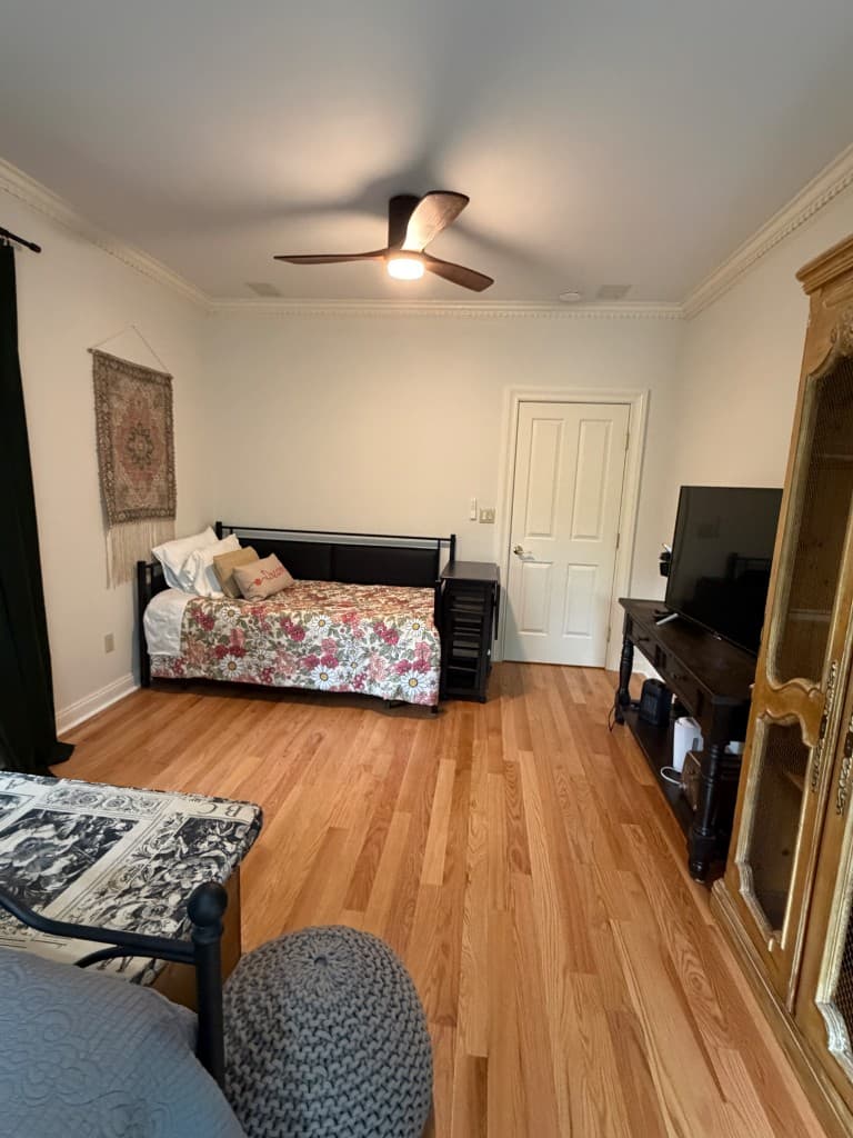 Cozy second bedroom with daybed, TV, and woven accents